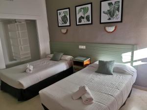 Postel nebo postele na pokoji v ubytování Hotel Costa Andaluza