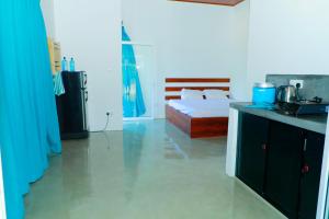 a bedroom with a bed and a kitchen with a sink at Zephyr Heights in Ahangama