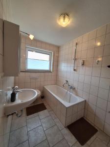 a bathroom with a tub and a sink at Hotel | Restaurant | Forellenzucht in Burgen +39 photos