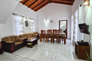 a living room with a couch and a table at Niwahana Holiday Resort in Polonnaruwa