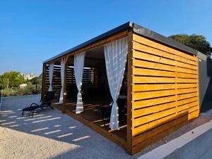 a building with curtains and chairs on a roof at Mobile home Tortuga in Drage +28 photos