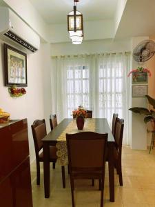 a dining room with a table and chairs at Adorable Panglao Vacation House in Dauis