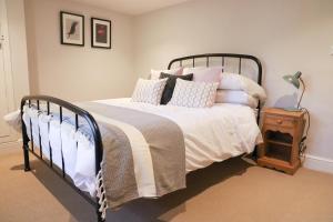 a bedroom with a bed with pillows on it at Beautifully refurbished 3 bedroom cottage in Ashdon