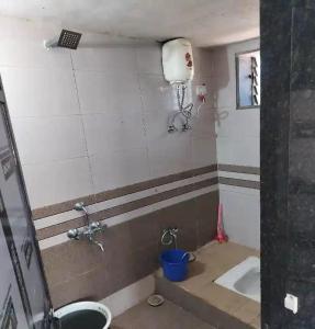 a bathroom with a sink and a toilet in a room at Jungle home stay in Devrukh