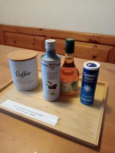 a wooden tray with three bottles of sauce and a paper at Il nido luminoso in Riomaggiore