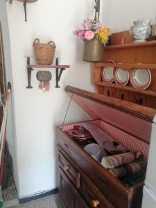 a cupboard with plates and bowls on a wall at Il nido luminoso in Riomaggiore