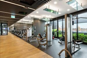 a gym with treadmills and elliptical machines at Magical Sunset SkyView BEST location in Brisbane in Brisbane