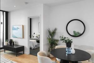 a living room with a table and a mirror at Magical Sunset SkyView BEST location in Brisbane in Brisbane +23 photos