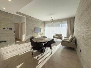 a dining room with a table and chairs at Malberry Park 103 - Modern Apt with Shared Heated Pool, Sauna, Gym, Jacuzzi in Paphos City