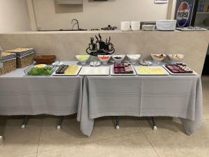 two tables with different types of food on them at Eyüp Sultan Palace Hotel in Istanbul