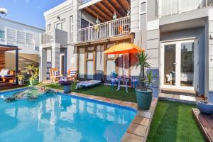 a swimming pool in the backyard of a house at The Sandcastle Guesthouse - Melkbosstrand in Melkbosstrand
