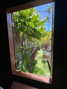 a window view of a garden from a patio at 1 BR Cozy Apartment in center of Seminyak in Seminyak +6 photos