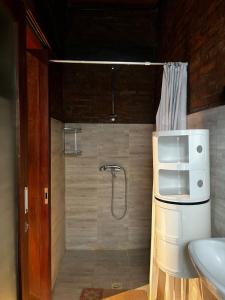 a bathroom with a shower and a sink at 1 BR Cozy Apartment in center of Seminyak in Seminyak