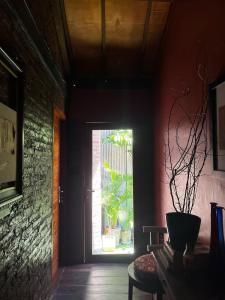 a room with a door with a window and a plant at 1 BR Cozy Apartment in center of Seminyak in Seminyak