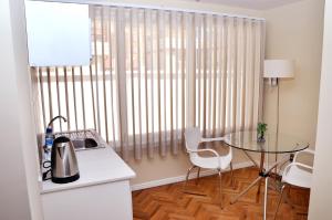 a small kitchen with a table and a window at Bolivian Rooms & Suites (Zona Sur) in La Paz