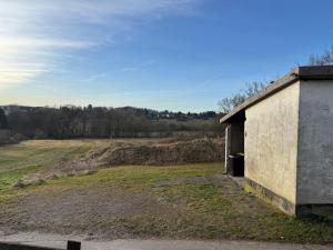 an old building with a field in the background at Ferienwohnung im Grünen in Witten
