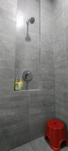 a shower with a red stool in a bathroom at Jia嘉 Homestay - Kuching Riverine Diamond Resort in Kuching +19 photos