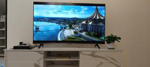 a flat screen tv sitting on top of a table at Jia嘉 Homestay - Kuching Riverine Diamond Resort in Kuching
