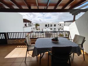 a table and chairs sitting on a balcony at Sea Carnation Well Located, Pool & Terrace in Los Pocillos
