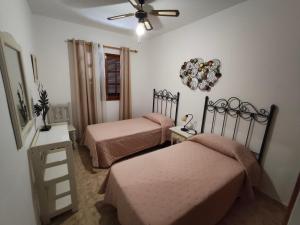 a bedroom with two beds and a ceiling fan at Sea Carnation Well Located, Pool & Terrace in Los Pocillos +28 photos