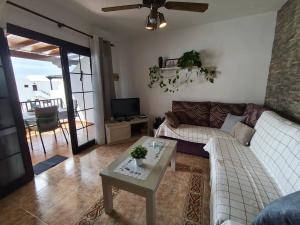 a living room with a couch and a table at Sea Carnation Well Located, Pool & Terrace in Los Pocillos