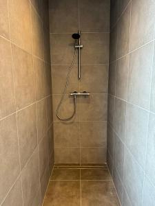 a bathroom with a shower with a shower head at Stay Every Day in Maldegem +30 photos