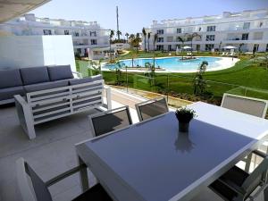 a patio with a table and chairs and a pool at Ocean Home - Costa Ballena in Costa Ballena
