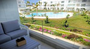 a balcony with a couch and a view of a pool at Ocean Home - Costa Ballena in Costa Ballena