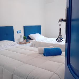 a group of white beds in a room at María PLAYA BRISA NG in Peniscola