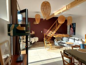 a living room with a couch and a staircase at Le 1881 Ampuis in Ampuis +38 photos