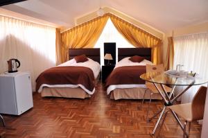 Giường trong phòng chung tại Bolivian Rooms & Suites (Zona Sur)