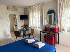 a room with a bed and a table with a mirror at Amaca in Mijas Costa