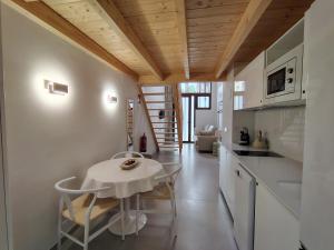a kitchen and dining room with a table and chairs at Mandarina Suites - Unique apartments in Valencia in Valencia