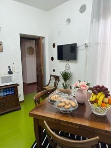 a wooden table with a bowl of fruit on it at Residenza Brancondi in Loreto +29 photos
