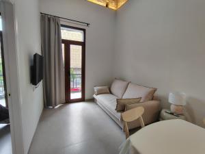 a living room with a couch and a table at Mandarina Suites - Unique apartments in Valencia in Valencia