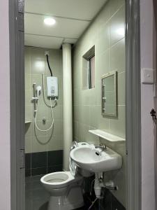 a bathroom with a shower and a toilet and a sink at Forever Green cameron in Brinchang