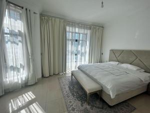 a bedroom with a large bed and large windows at Dubai mall Aparment in Dubai +36 photos