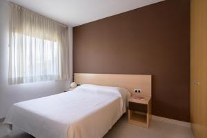 Postel nebo postele na pokoji v ubytování SG Costa BCN Apartments