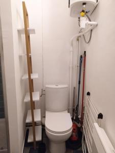 a bathroom with a toilet and shelves in it at Studio l'Olivette T1 in Avignon