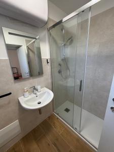 a bathroom with a sink and a shower at MARIS Apartments & Bedrooms in Alghero