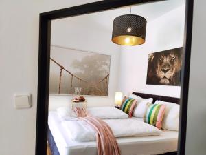 two beds in a room with a mirror at Modernes Loft-Erlebnis mit Fitnessbereich & Heimkino in Magdeburg