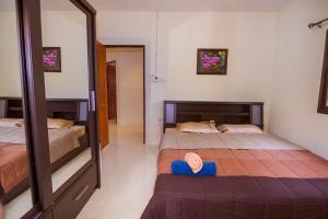 a bedroom with two beds and a mirror at Villa Marcello in Pattaya South +6 photos