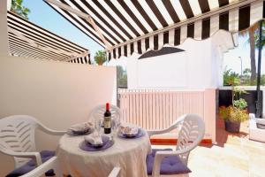 a table with a bottle of wine on a patio at Playa del Cura - Mar Paraiso in Playa del Cura