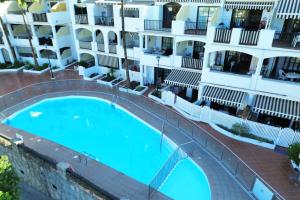 an overhead view of a swimming pool in front of apartment buildings at Playa del Cura - Mar Paraiso in Playa del Cura +2 photos