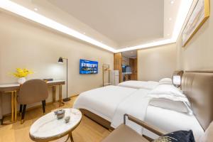 a hotel room with a large bed and a desk at Pazhou Exhibition in Guangzhou +35 photos