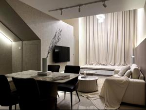a living room with a table and a couch at Loft Suite Eko Cheras in Kuala Lumpur