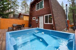 a swimming pool in front of a house at Moonridge Manor Modern, Cozy Retreat with Hottub! in Big Bear Lake