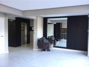 a lobby with two couches in a building at Apto6 com WI-FI e garagem e 100 a av Brasil in Passo Fundo