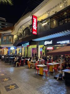 a group of people sitting at tables outside a restaurant at Elegant 1BR with Great View, Panoramic Pool Near Ortigas CBD - 24 in Manila +53 photos