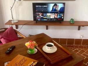 un tavolino con una tazza di caffè e una TV di Son & Roberto a Karangasem